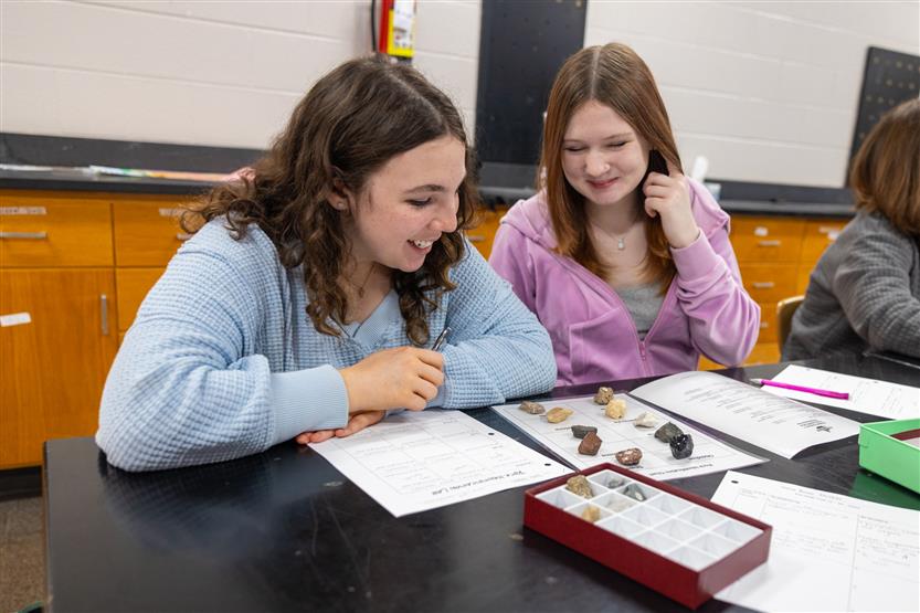Students study rocks in a science lab